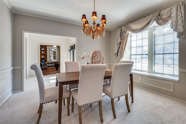 dining area with ornamental molding, a decorative wall, an inviting chandelier, and light colored carpet