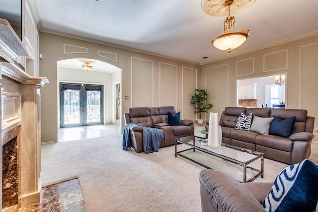 2701 Shadow Dr W, Arlington, TX 76006 - carpeted living area with crown molding, a decorative wall, a fireplace, french doors, and arched walkways
