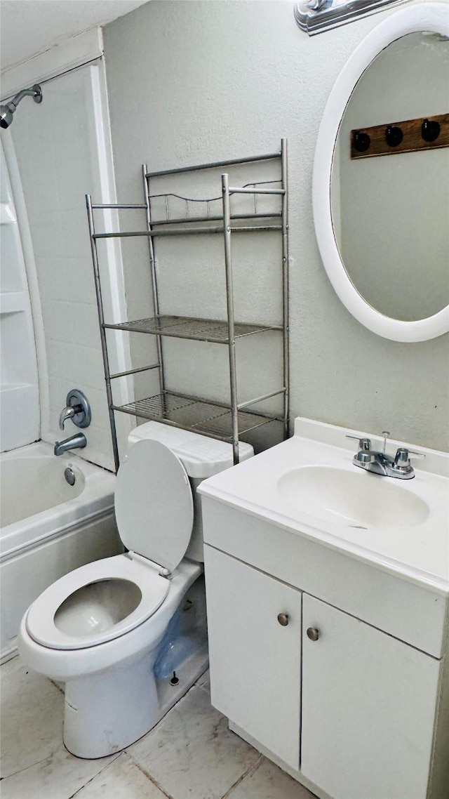 bathroom with toilet, marble finish floor,  shower combination, and vanity