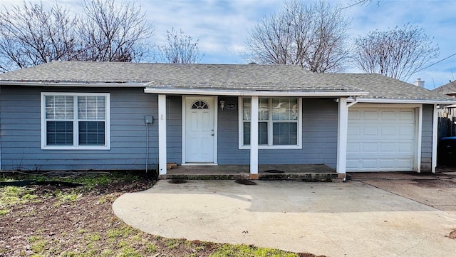 ranch-style house featuring an attached garage, covered porch, concrete driveway, and roof with shingles