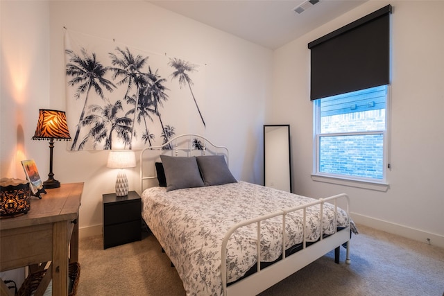 bedroom with carpet flooring, visible vents, and baseboards