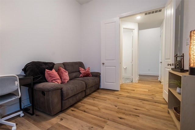 interior space with light wood finished floors, baseboards, and visible vents