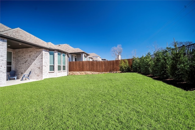 view of yard with a patio area and a fenced backyard