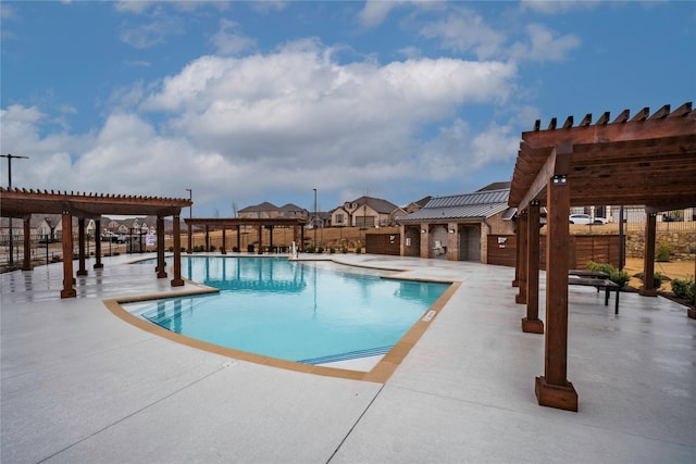 community pool featuring a patio area, fence, and a pergola