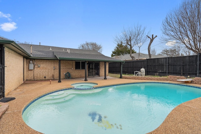 view of pool featuring a patio area, a pool with connected hot tub, fence, and a diving board