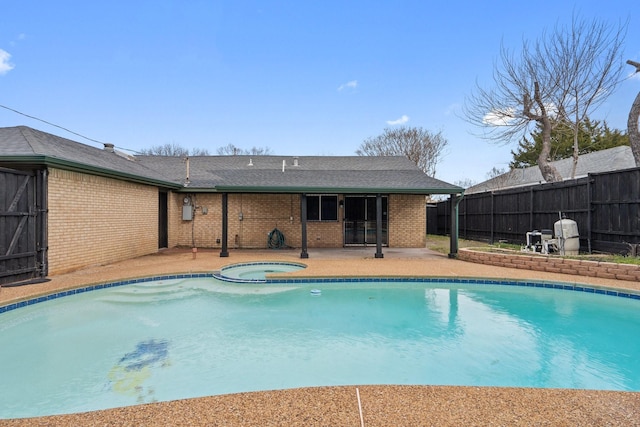 view of swimming pool featuring a fenced in pool, fence, a patio, and an in ground hot tub