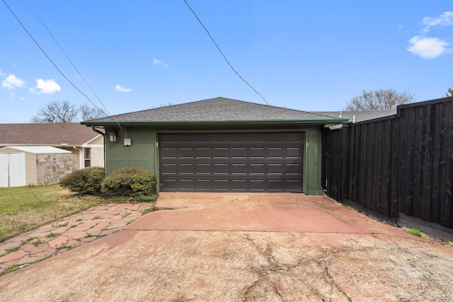 exterior space featuring concrete driveway and fence