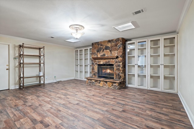 unfurnished living room featuring visible vents, crown molding, and wood finished floors