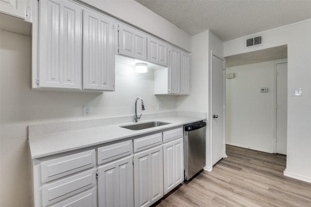 kitchen with a sink, visible vents, light wood-style floors, light countertops, and dishwasher