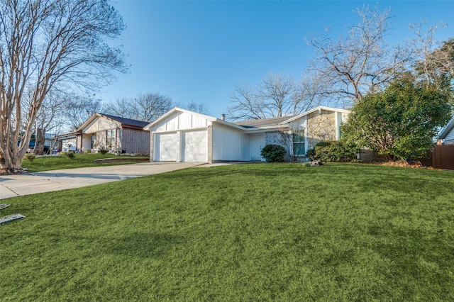 view of front of property with a garage, driveway, and a front lawn