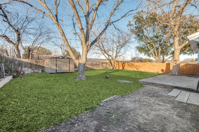 view of yard featuring an outbuilding, a patio area, a fenced backyard, and a storage shed