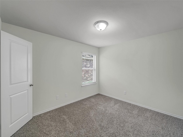 empty room with carpet and baseboards