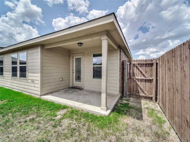 exterior space with a gate, a patio, and fence