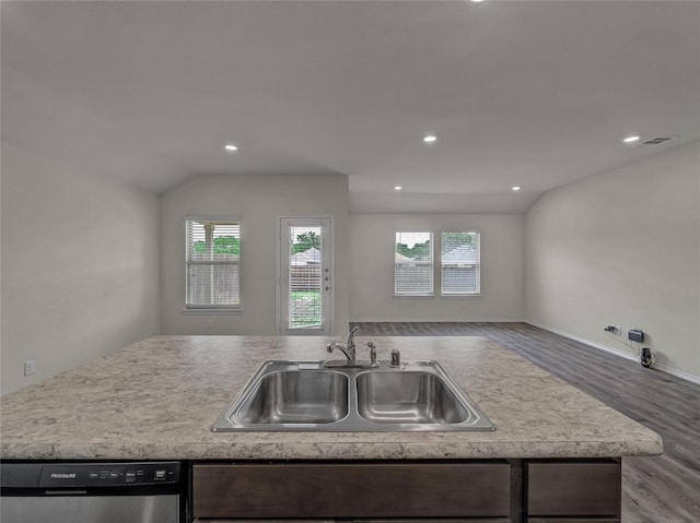 kitchen featuring wood finished floors, a sink, visible vents, open floor plan, and dishwasher