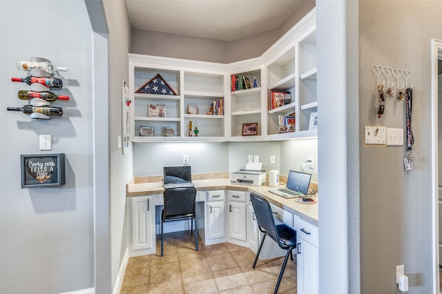 office area with built in study area and baseboards