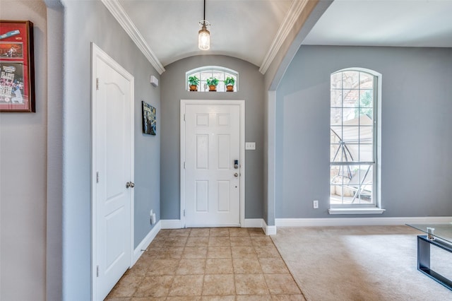 foyer featuring lofted ceiling, light carpet, arched walkways, and baseboards