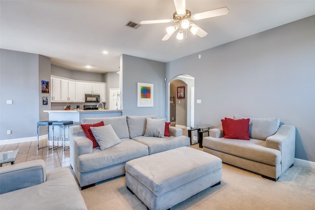 living room with baseboards, visible vents, arched walkways, a ceiling fan, and recessed lighting