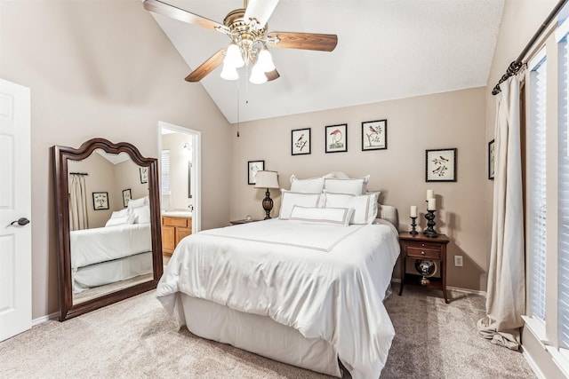 bedroom with baseboards, carpet flooring, vaulted ceiling, and ensuite bath