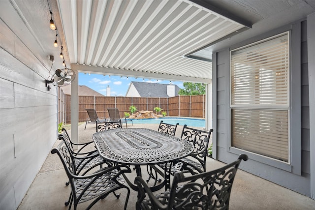 view of patio with outdoor dining area, a fenced backyard, and a fenced in pool