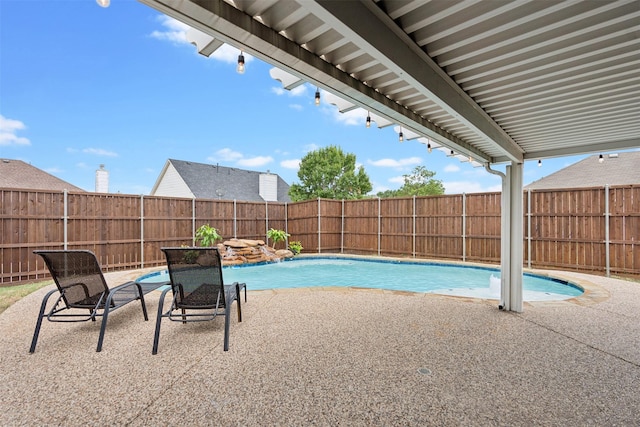 view of swimming pool featuring a patio area, a fenced backyard, and a fenced in pool