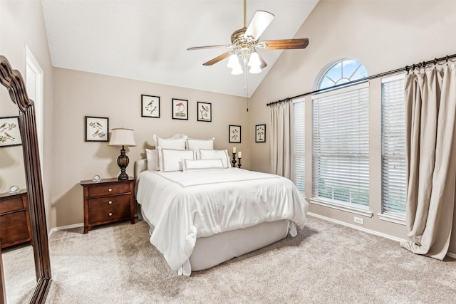 bedroom featuring light carpet, high vaulted ceiling, baseboards, and a ceiling fan