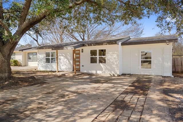 back of property featuring fence