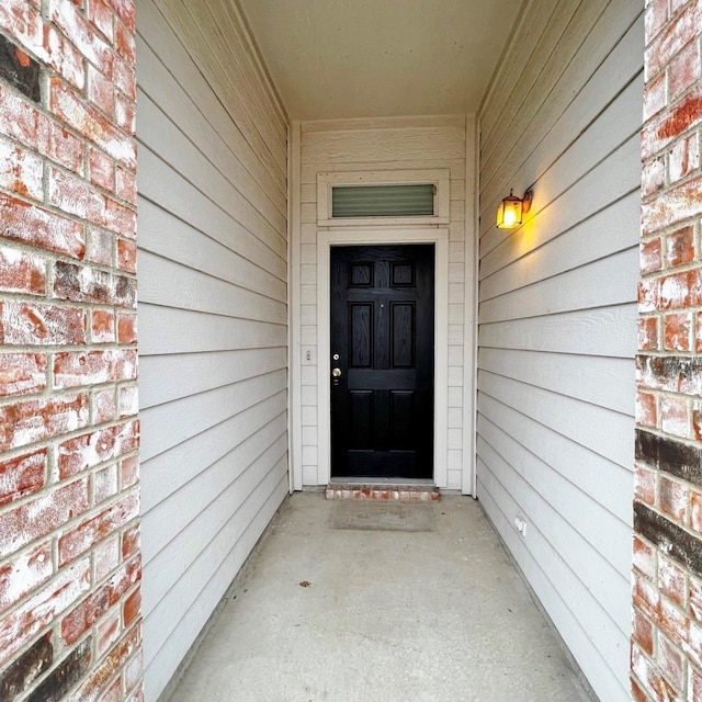 property entrance with brick siding