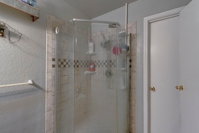 full bath featuring a stall shower and a textured wall