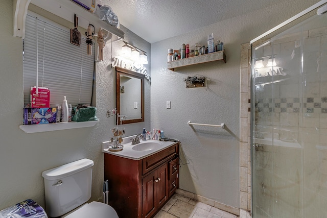 full bath with a stall shower, toilet, a textured ceiling, and vanity