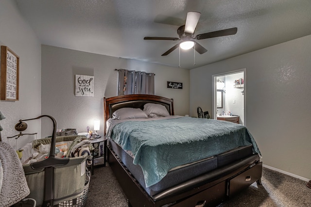 bedroom with a textured wall, dark carpet, connected bathroom, a textured ceiling, and baseboards