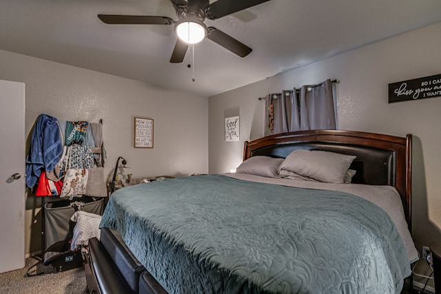 bedroom featuring carpet flooring, a textured wall, and ceiling fan