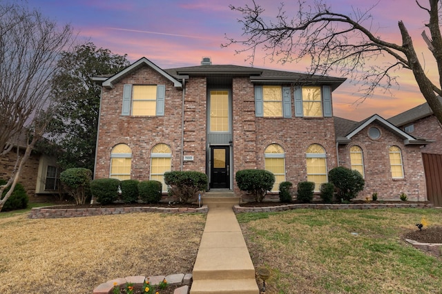 7100 Amethyst Ln, Plano, TX 75025 - view of front facade featuring a yard, brick siding, and roof with shingles