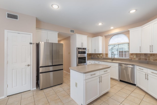 kitchen with light tile patterned floors, visible vents, appliances with stainless steel finishes, and a sink