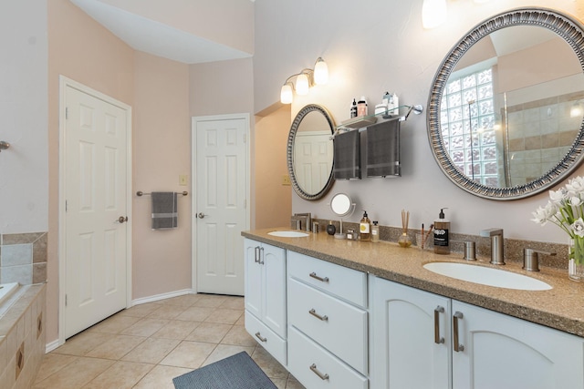7100 Amethyst Ln, Plano, TX 75025 - full bath featuring tile patterned floors, tiled shower, double vanity, tiled bath, and baseboards
