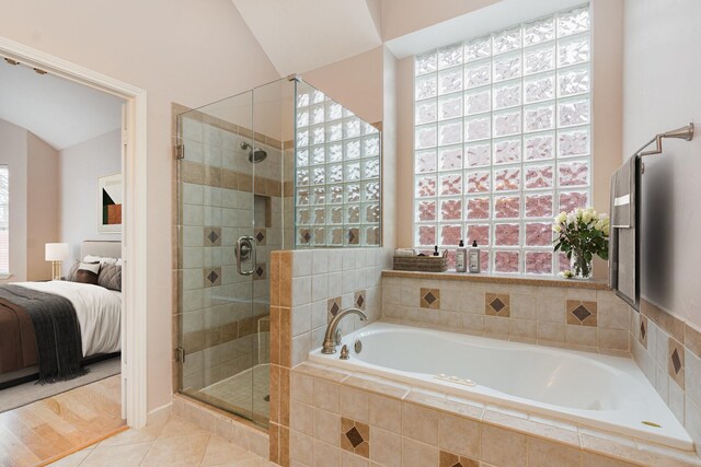 7100 Amethyst Ln, Plano, TX 75025 - ensuite bathroom with a stall shower, plenty of natural light, a garden tub, and tile patterned flooring