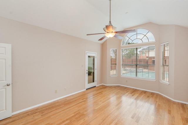 unfurnished room with lofted ceiling, light wood-style flooring, and baseboards