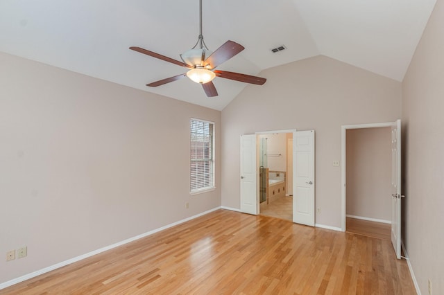 unfurnished bedroom featuring baseboards, visible vents, vaulted ceiling, and light wood finished floors