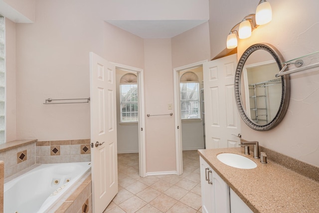 full bath with baseboards, a shower with door, a jetted tub, tile patterned flooring, and vanity