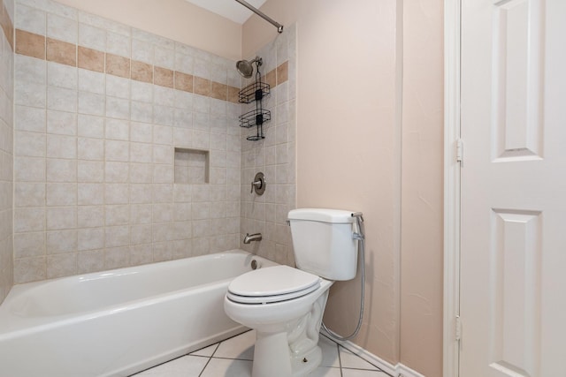 bathroom featuring toilet, tile patterned flooring, and bathing tub / shower combination