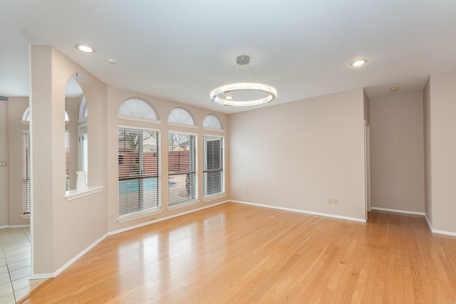 unfurnished room with light wood-style floors, recessed lighting, and baseboards