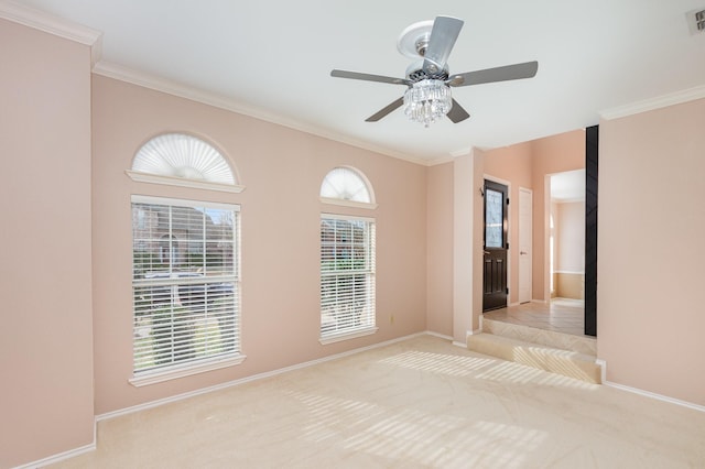 empty room featuring carpet floors, plenty of natural light, visible vents, and crown molding