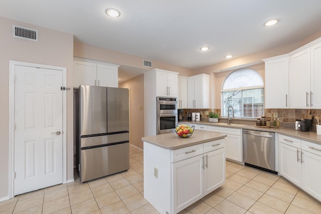 7100 Amethyst Ln, Plano, TX 75025 - kitchen featuring appliances with stainless steel finishes, a sink, backsplash, light tile patterned flooring, and recessed lighting
