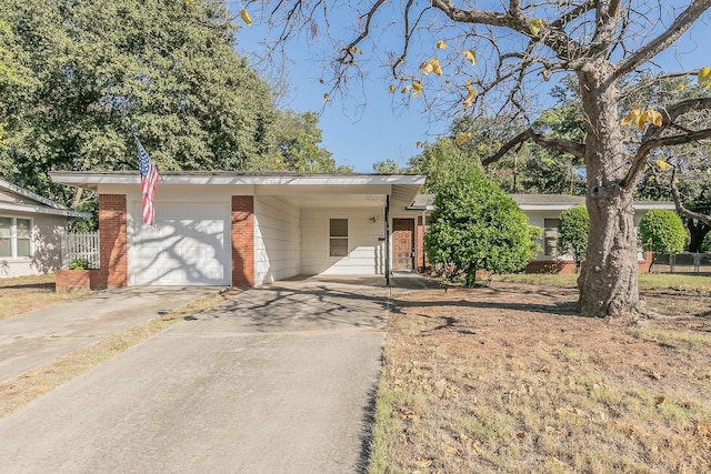 single story home featuring driveway, a garage, and brick siding