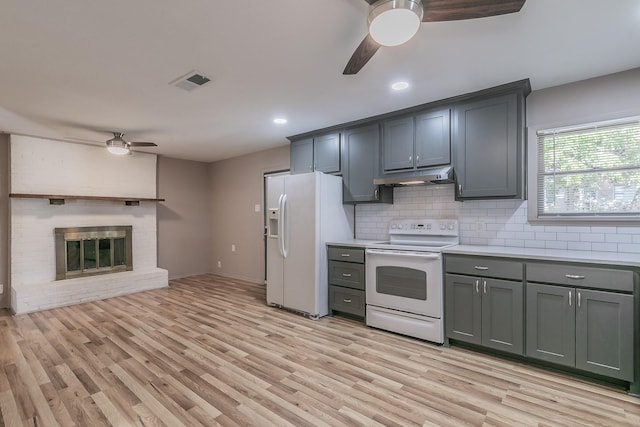 kitchen with visible vents, gray cabinetry, ceiling fan, white appliances, and under cabinet range hood