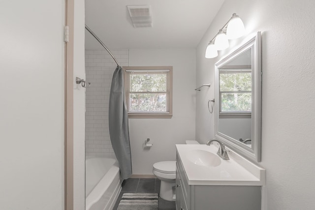 full bath featuring a wealth of natural light, visible vents, vanity, and tile patterned floors