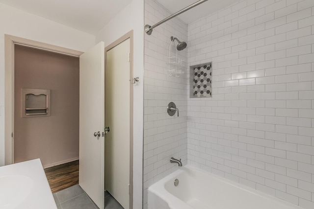 full bath with  shower combination, tile patterned flooring, and a sink