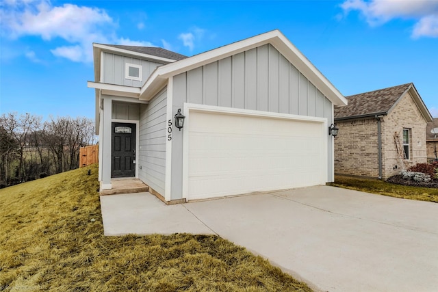 view of front of property featuring a garage, driveway, board and batten siding, and roof with shingles