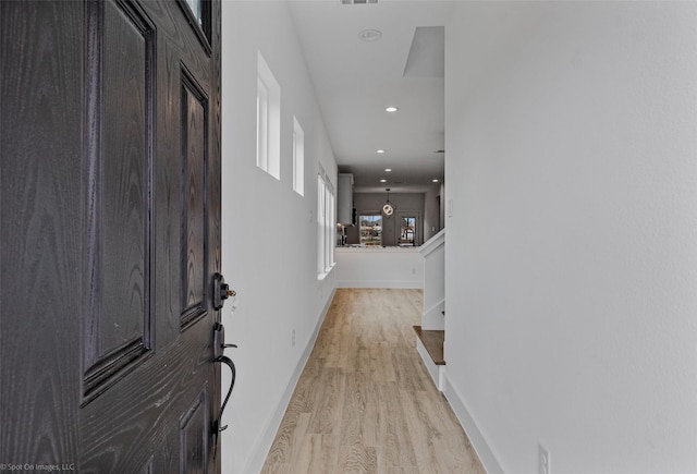 foyer with light wood-style flooring, visible vents, baseboards, and recessed lighting