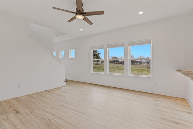 interior space featuring light wood-style flooring, baseboards, ceiling fan, and recessed lighting