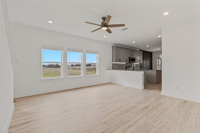 unfurnished living room with light wood-style floors, recessed lighting, visible vents, and ceiling fan